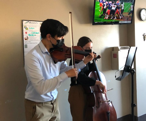 Violinist Luke Green (left) organized the young musicians group as part of his Eagle Scout Award project.